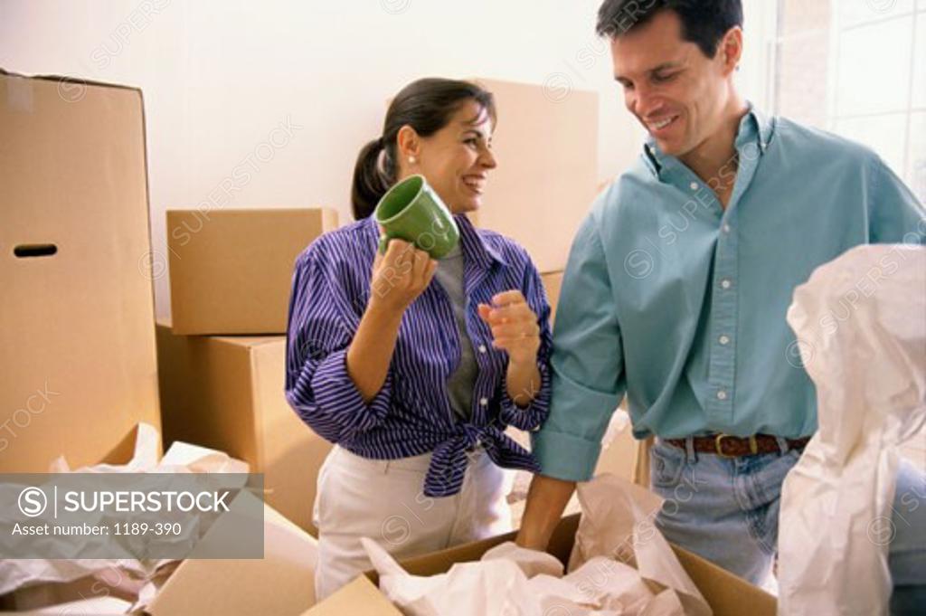 Stock Photo: 1189-390 Young couple unpacking in their new house