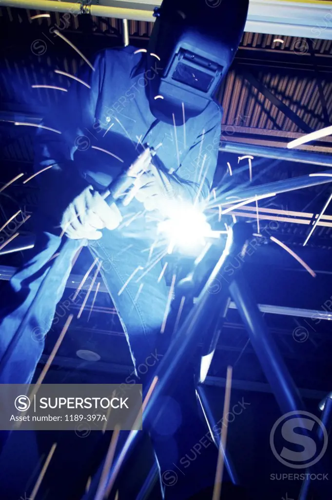 Welder welding metal