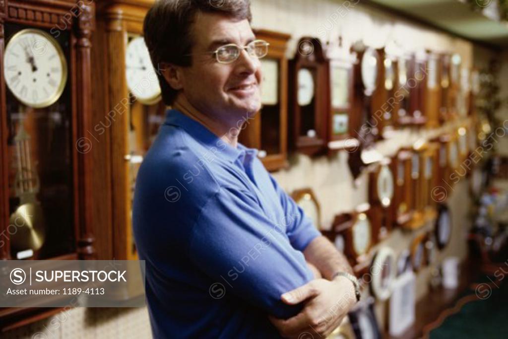 Stock Photo: 1189-4113 Side profile of a mature man standing in a store with his arms folded