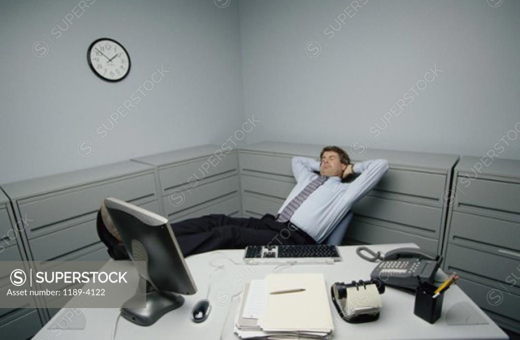 Stock Photo: 1189-4122 High angle view of a businessman with his feet up on a desk