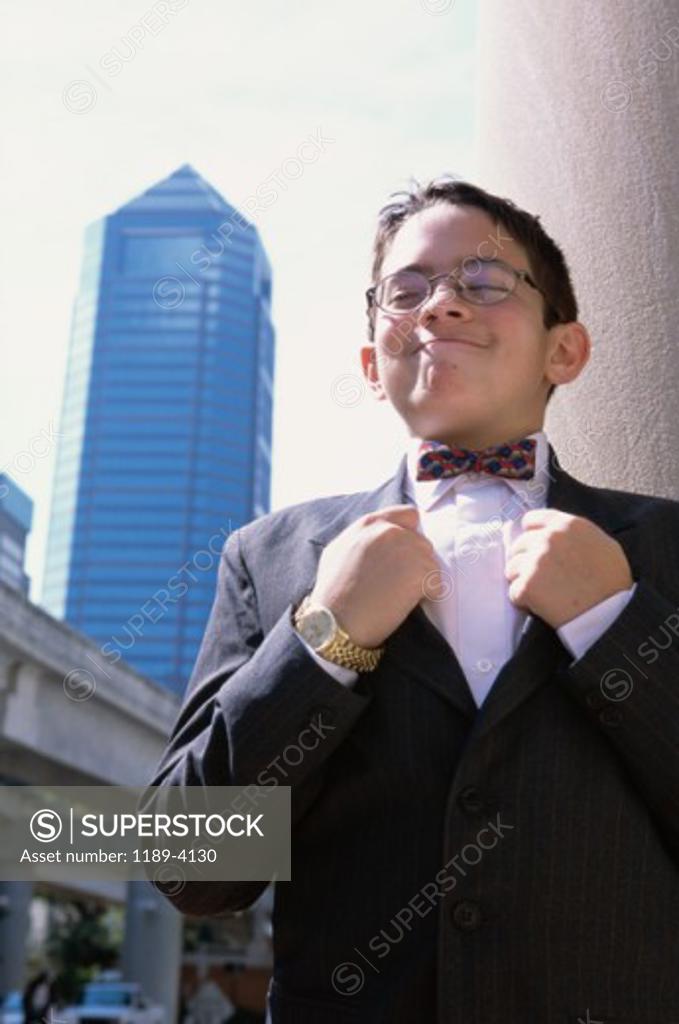Stock Photo: 1189-4130 Portrait of a boy holding the lapels of his coat