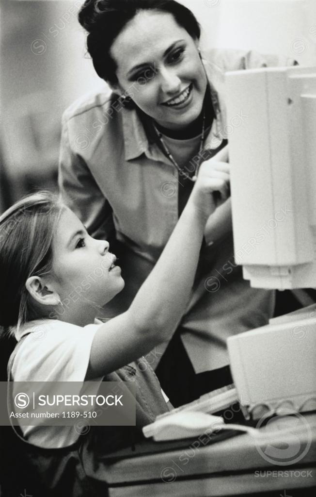 Stock Photo: 1189-510 Female teacher and her student in front of a computer