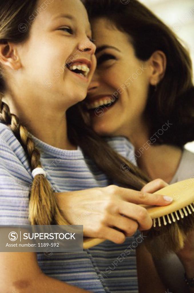 Stock Photo: 1189-592 Side profile of a mother and her daughter smiling