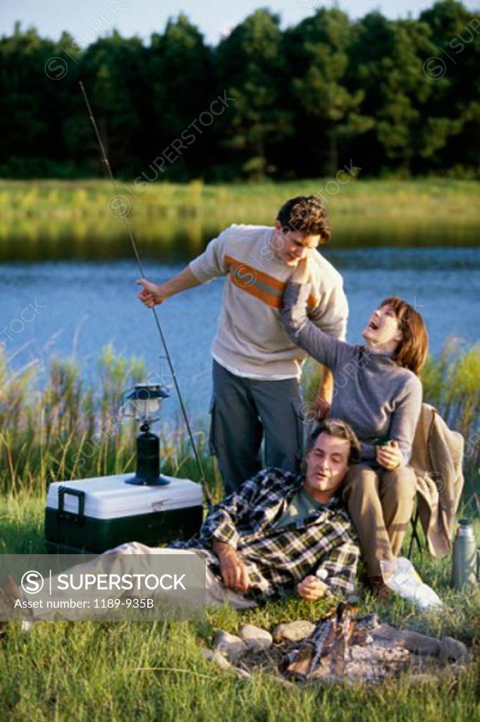 Stock Photo: 1189-935B Mature couple with their son near a campfire