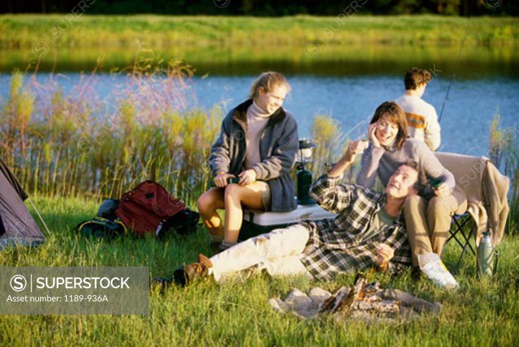 Stock Photo: 1189-936A Parents and their daughter sitting near a campfire