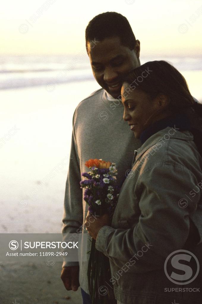 Stock Photo: 1189R-2949 Young couple holding each other at the beach