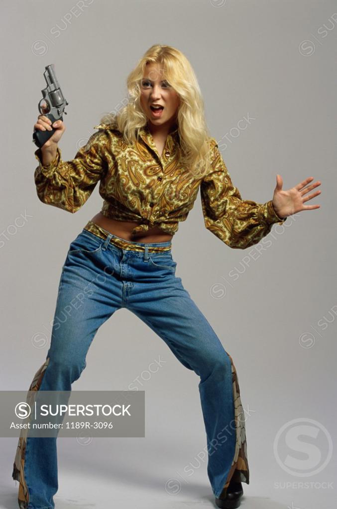 Stock Photo: 1189R-3096 Portrait of a young woman holding a handgun