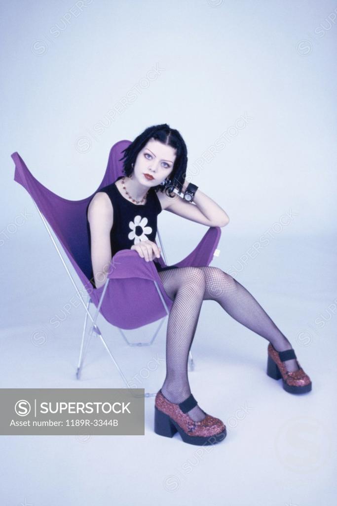 Stock Photo: 1189R-3344B Portrait of a teenage girl sitting on a chair