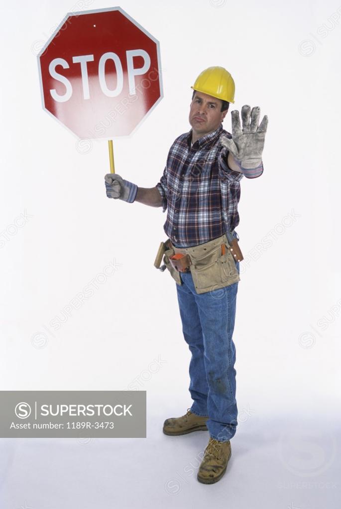 Stock Photo: 1189R-3473 Portrait of a worker standing with a stop sign