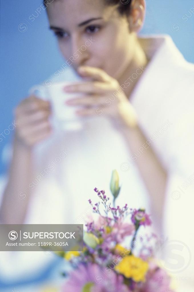 Stock Photo: 1189R-3605A Young woman drinking from a cup