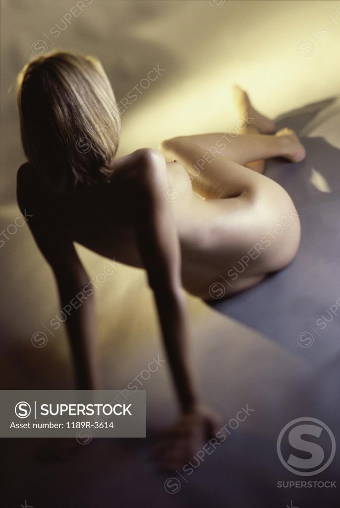 Stock Photo: 1189R-3614 High angle view of a naked young woman sitting on the floor