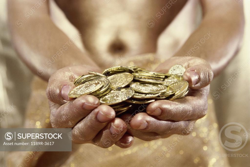 Stock Photo: 1189R-3617 Person holding gold coins