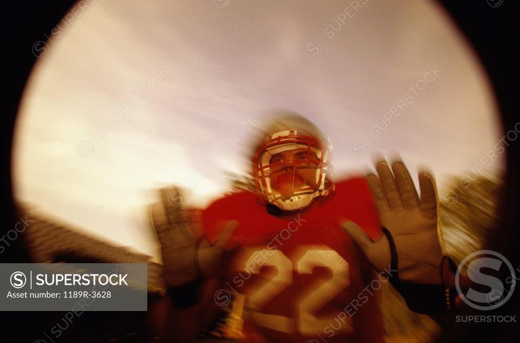 Stock Photo: 1189R-3628 Low angle view of an American football player in a tackle pose