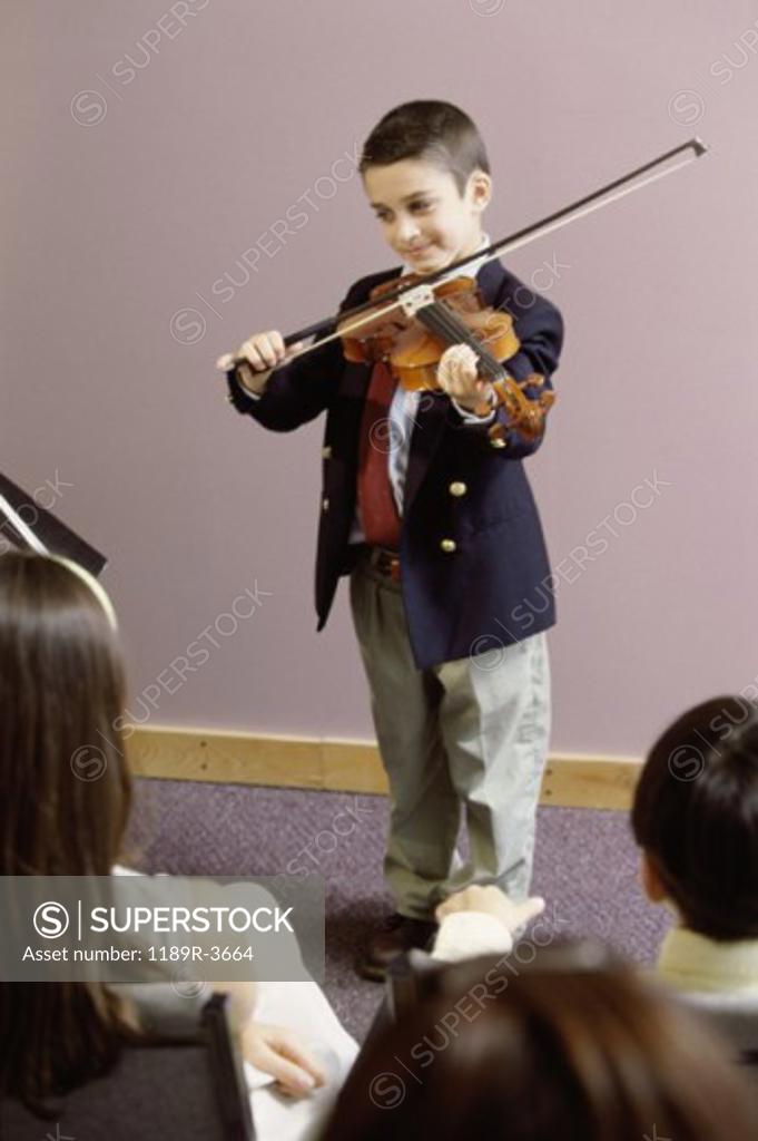 Stock Photo: 1189R-3664 Boy playing a violin in front of an audience