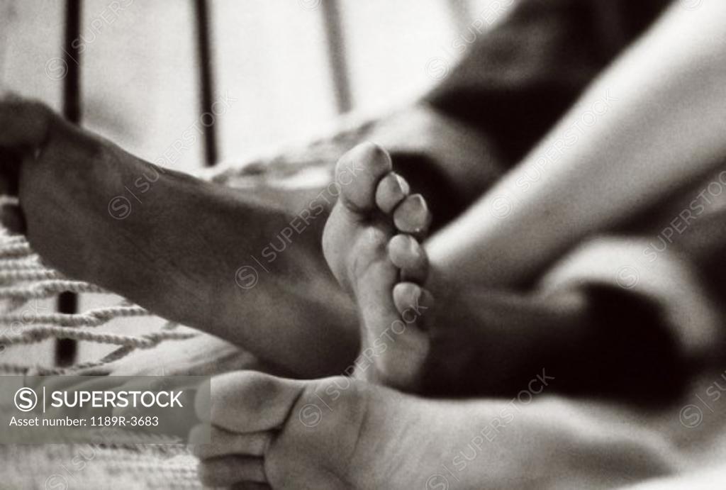 Stock Photo: 1189R-3683 Feet of a couple lying in a hammock