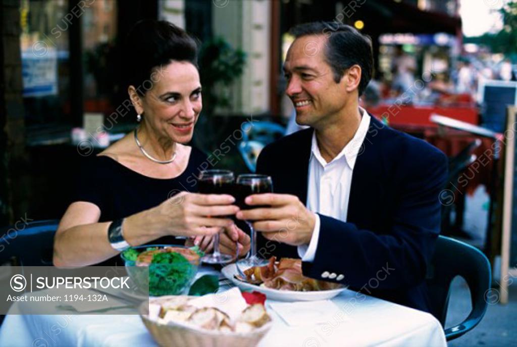 Stock Photo: 1194-132A Mature couple toasting with red wine