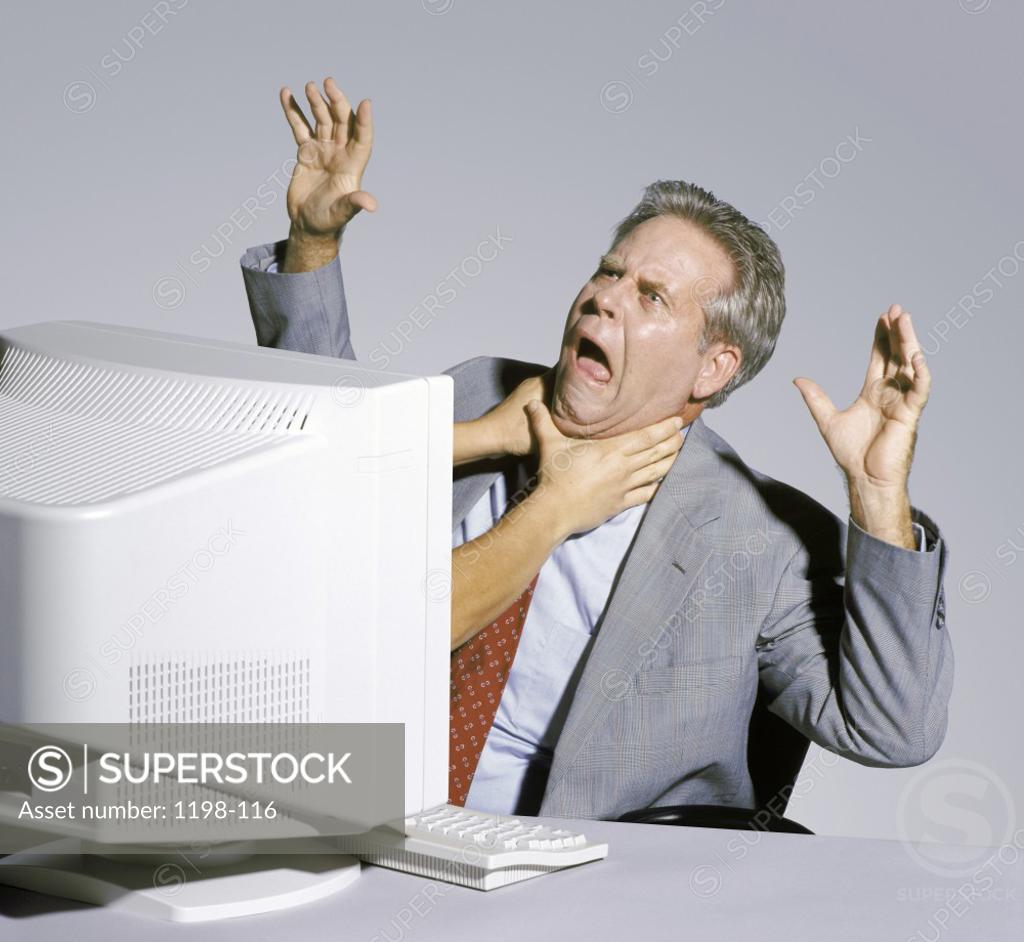 Stock Photo: 1198-116 Businessman sitting in front of a computer monitor