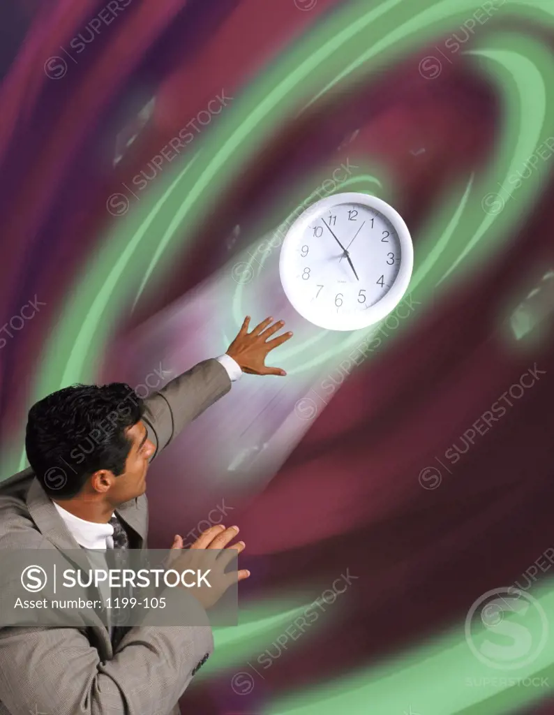Businessman shielding his face from a clock