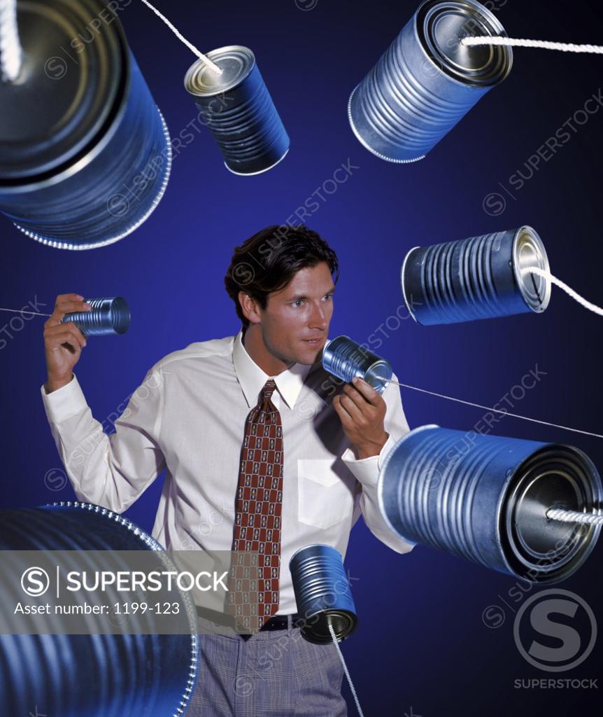 Stock Photo: 1199-123 Businessman talking into tin cans