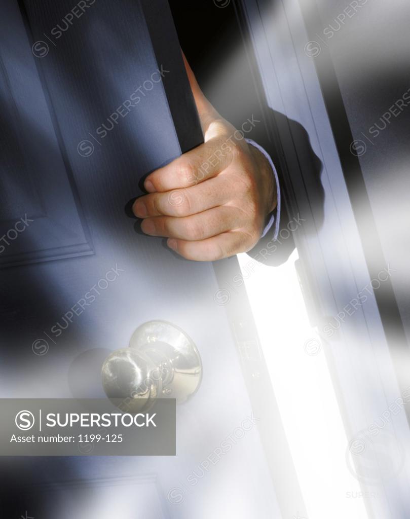 Stock Photo: 1199-125 Person's hand holding a door
