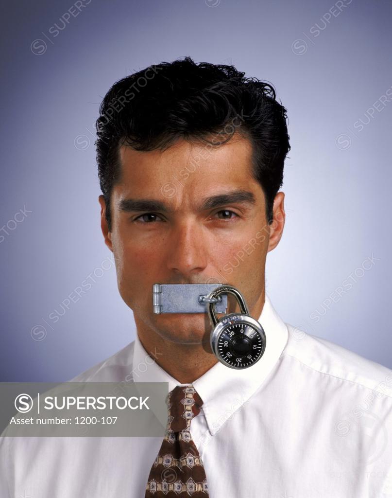 Stock Photo: 1200-107 Portrait of a businessman with his lips padlocked