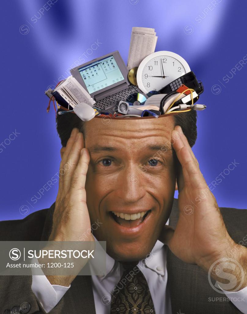 Stock Photo: 1200-125 Businessman with gadgets in his head
