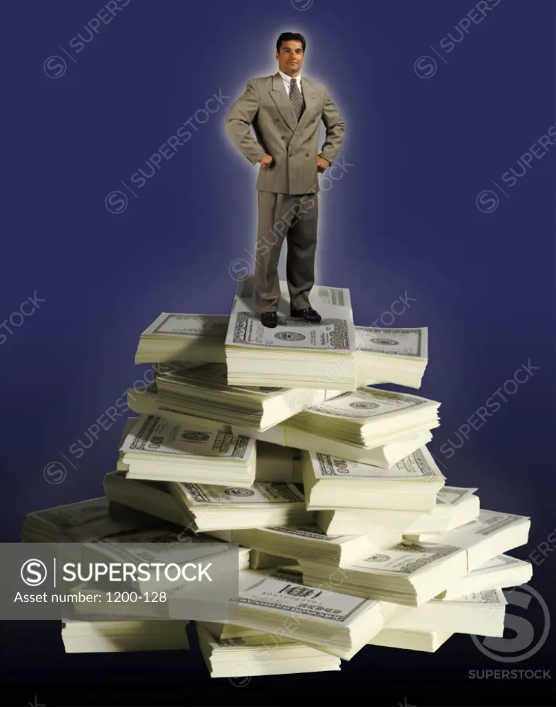 Businessman standing on a stack of American dollar bills
