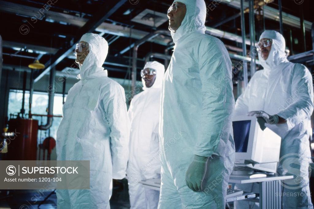 Stock Photo: 1201-104 Group of scientists wearing protective clothing standing in a laboratory