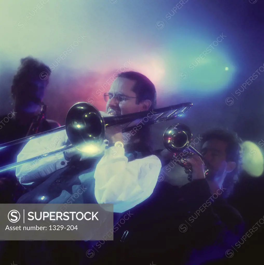 Pop musician playing a trombone in a nightclub
