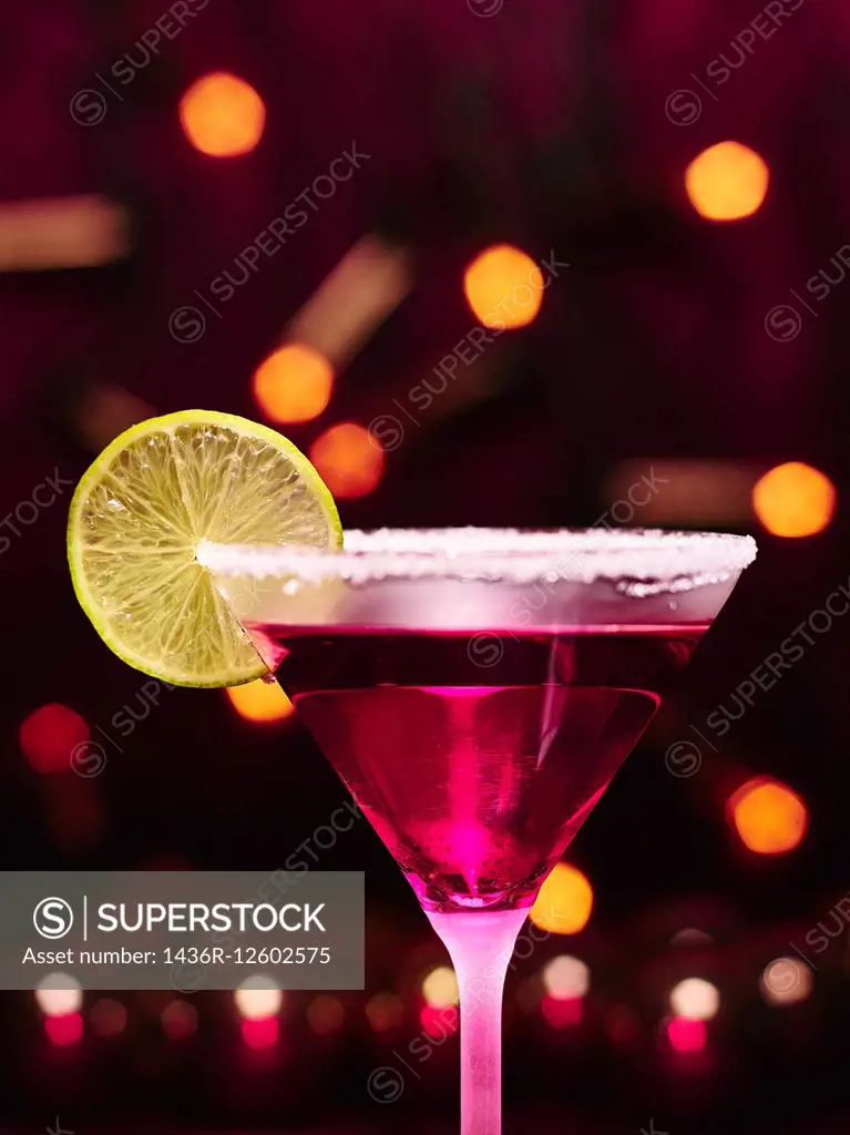 Martini glass and alcoholic beverage with a lime slice, sugar rim, girly christmas theme.