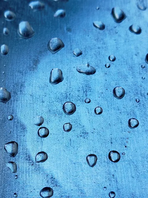water droplets on a metal plate with holes, close-up. Macro background.