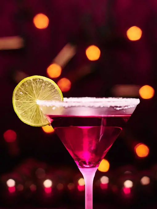 Martini glass and alcoholic beverage with a lime slice, sugar rim, girly christmas theme.