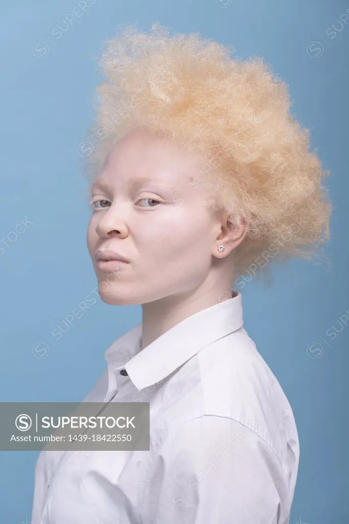Studio portrait of albino woman in white shirt