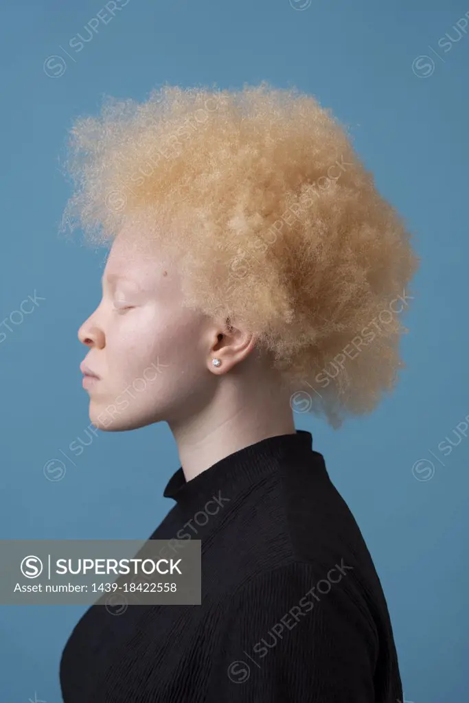 Studio portrait of albino woman with eyes closed