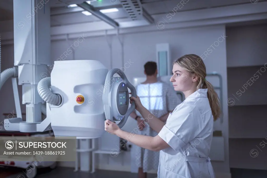 Radiologist setting up chest x-ray in hospital