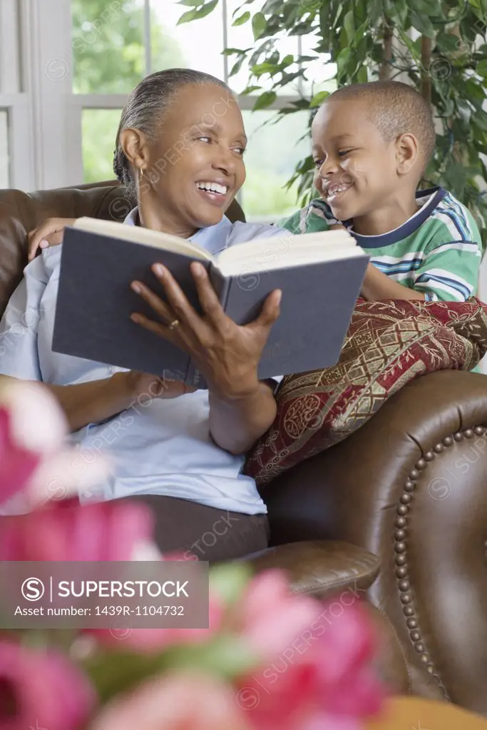 A grandmother and grandson reading a book