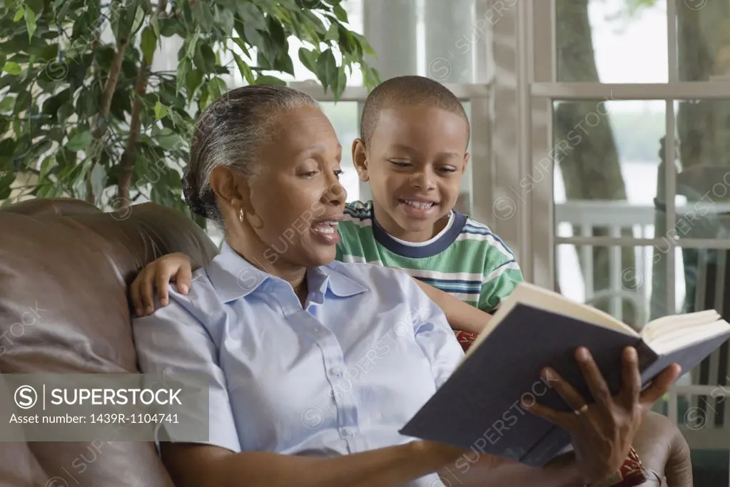 A grandmother and grandson reading a book