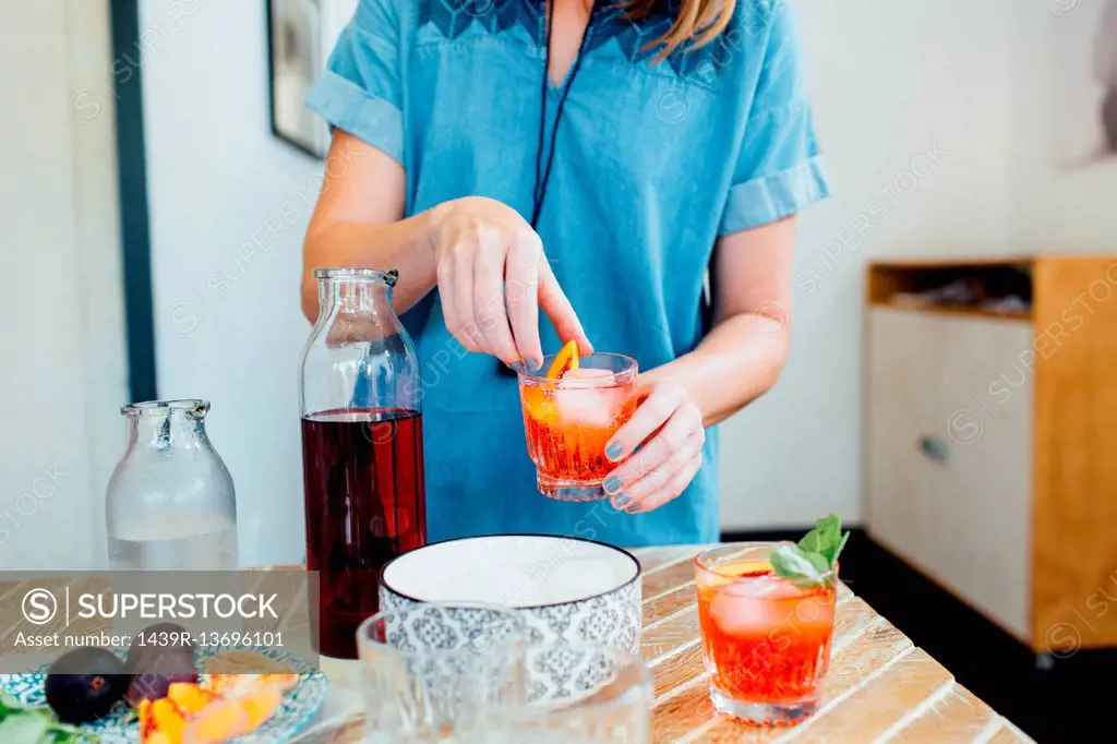 Woman preparing cocktail