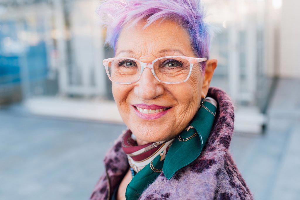 Italy, Portrait of smiling fashionable senior woman