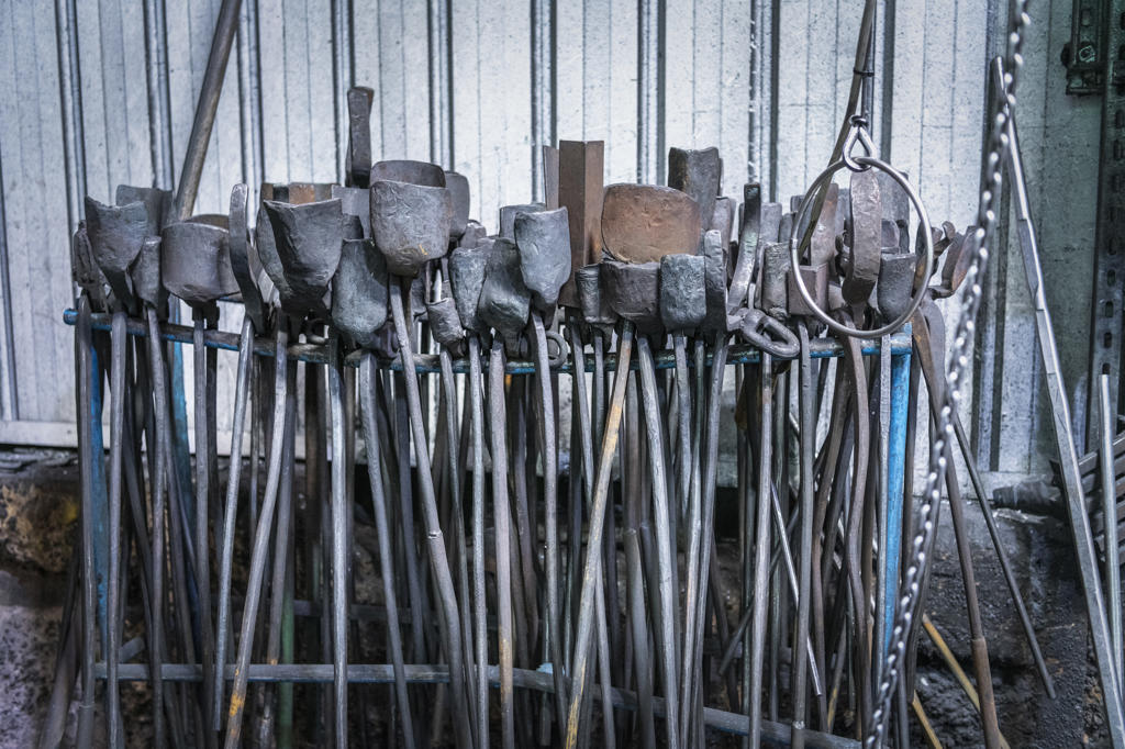 Rows of tools and tongs in industrial forge