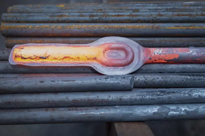 Hot forged steel part in industrial forge