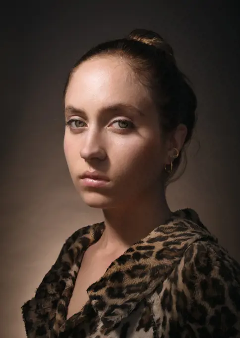 Studio portrait of serious woman wearing fake fur