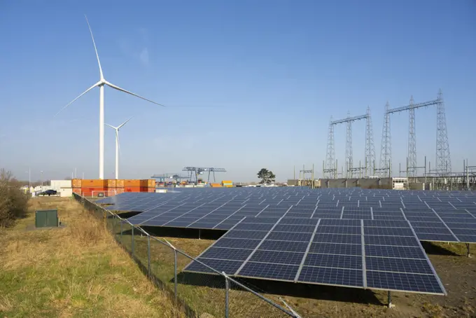 Netherlands, Solar farm and wind turbines in harbor