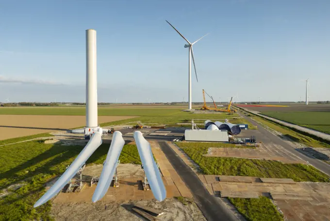 Netherlands, Emmeloord, Wind turbines under construction in rural landscape