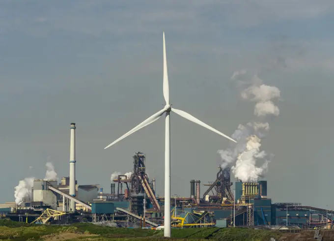 Netherlands, IJmuiden, Wind turbine in front of steel mill