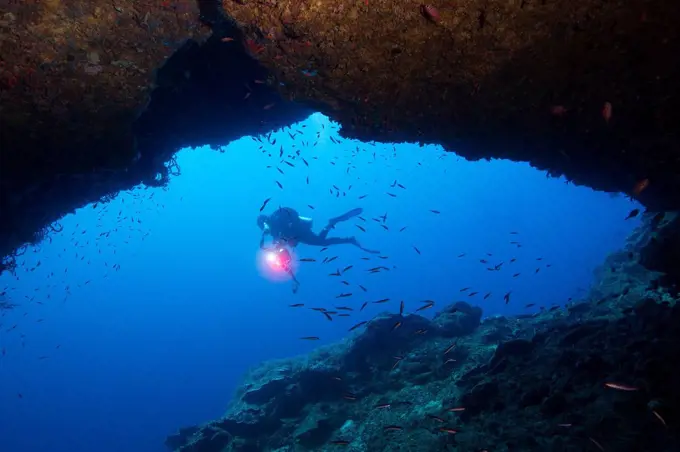 Diver framed by cavern.
