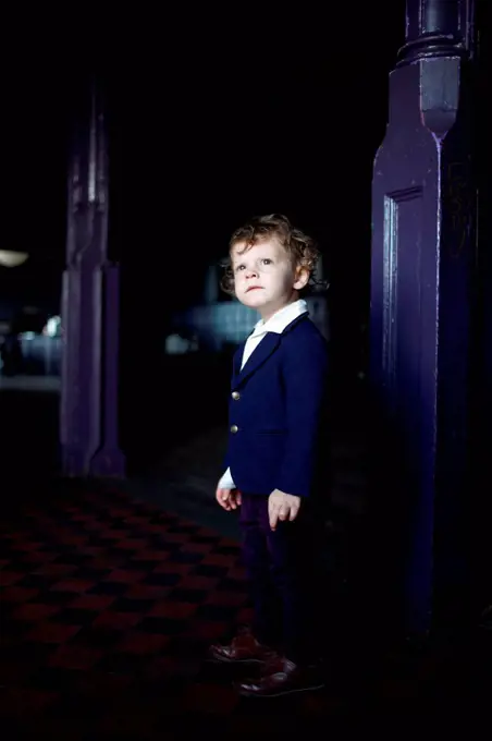 Little boy in room, wearing mod clothing