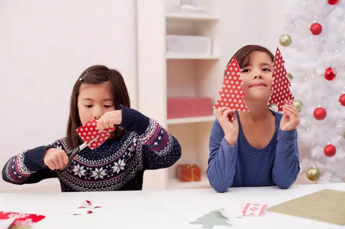 Girls holding and making Christmas decorations