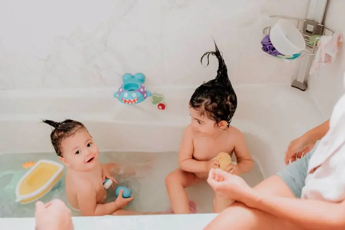 Parents with daughter at bath time