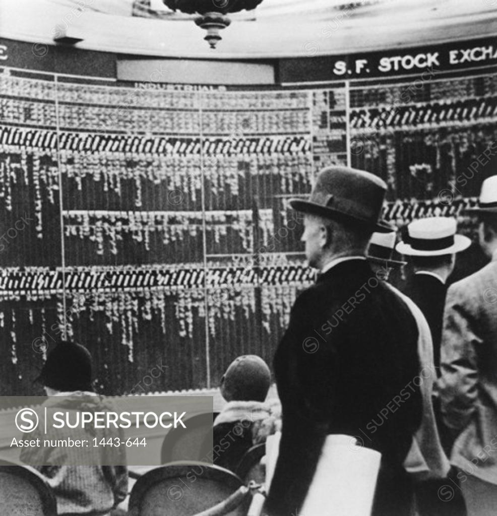 Stock Photo: 1443-644 Rear view of shareholders in a stock exchange looking at a stock market data, 1929